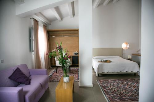 a living room with a bed and a couch at Il Vigneto Resort in Menfi