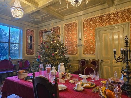 a table with a christmas tree in a room at Solvang in Assens