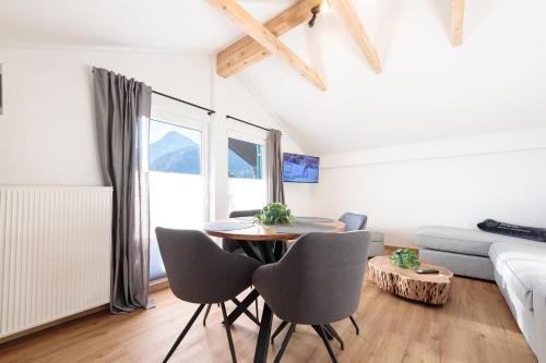 a living room with a table and chairs and a couch at Heu22 Heuboden in Farchant