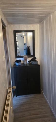 a hallway with a mirror and a dresser in a room at Ferienwohnung Chandony in Konz
