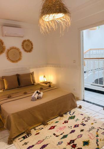 a bedroom with a bed and a large window at Riad Kechin Beldi in Marrakesh