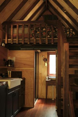 a kitchen with wooden walls and a wooden ceiling at Rancho Relaxo Tiny House - in town sanctuary in Margaret River Town
