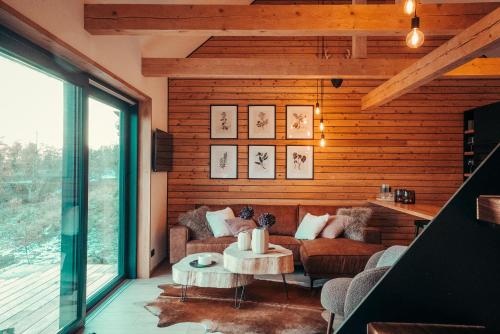 a living room with a couch and a table at Cozy Chalet in Smolné Pece