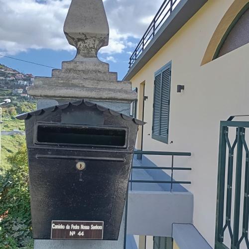 a mailbox outside of a house with a building at Yellow Owl II - Bedroom III in Campanário