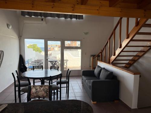 a living room with a table and a couch at Bajada 1 in Las Grutas