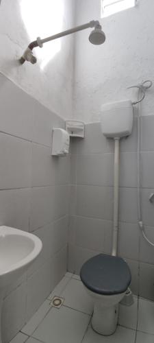 a white bathroom with a toilet and a sink at casa n 3 jeri in Jericoacoara