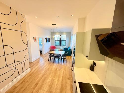 a living room and dining room with a table at Central - Free parking- Sleeps 6 - Stylish Apt in Bristol