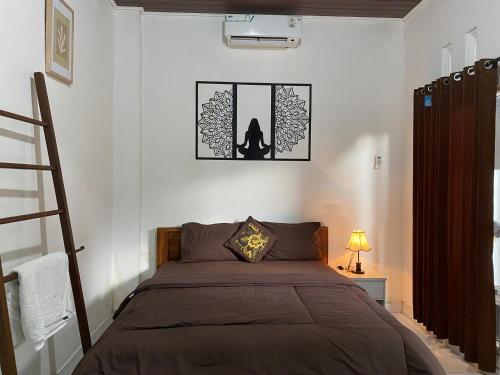 a bedroom with a bed with a cat sitting on it at Pondok tulamben in Karangasem