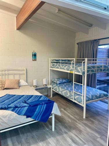 a bedroom with two bunk beds in a room at The Marlin House Iluka in Iluka