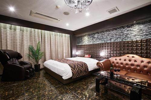 En eller flere senge i et værelse på ホテルリンクス柏市豊四季店