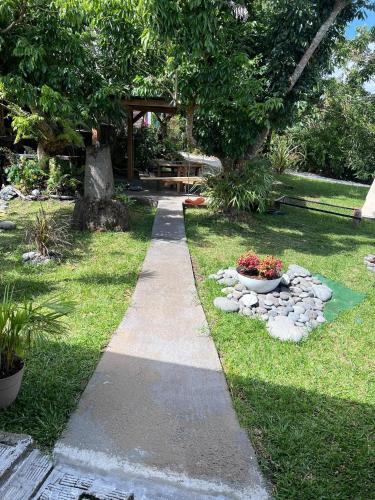 a path in a garden with flowers in a park at Fleur de Canne in Saint-Benoît