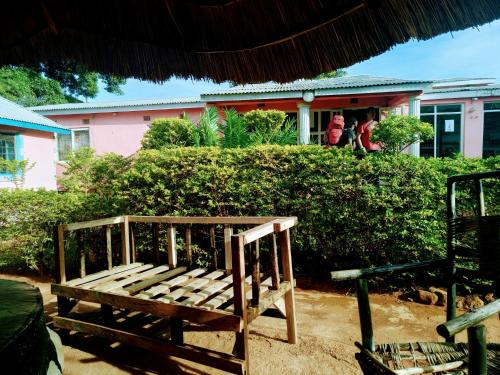 a wooden bench sitting in front of a building at Mount Mulanje Stopover in Peremwe
