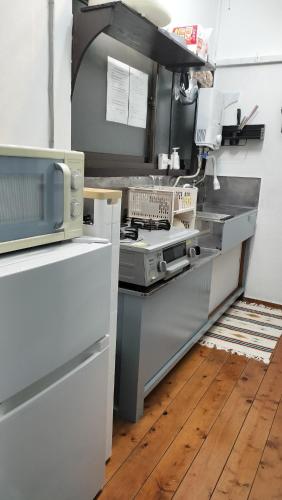 a kitchen with a stove top oven in a kitchen at 103個室元芸者の隠れ宿湯河原 in Yugawara