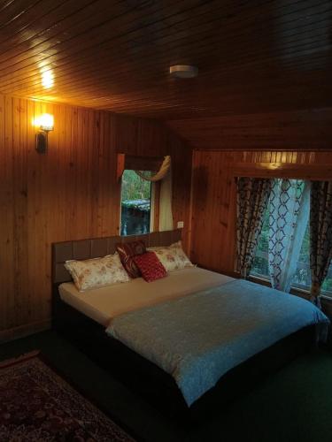 a large bed in a room with a window at Ghising Newas Homestay in Jālāpahār