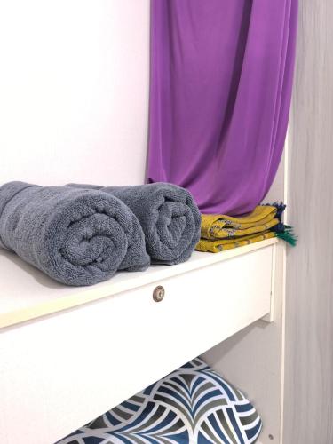 a pile of towels sitting on top of a shelf at Nani Homestay in Kampong Bukit Kuang