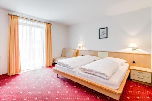 A bed or beds in a room at Pension Haus am See