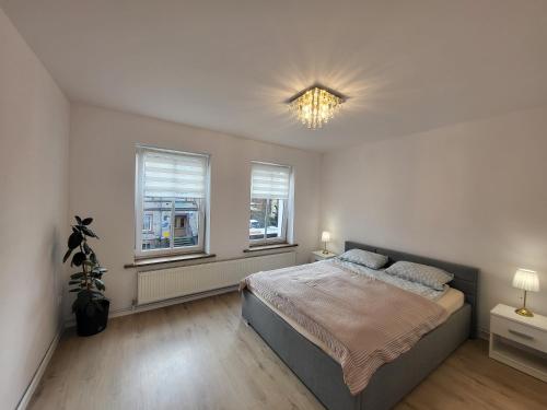 En eller flere senge i et værelse på Apartament Daisy