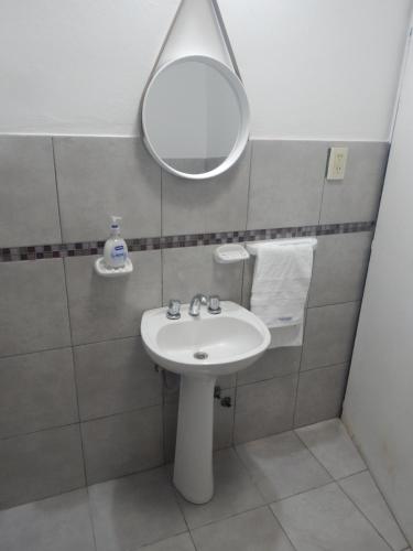 a bathroom with a sink and a mirror at San Cayetano in Paraná