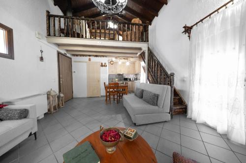 a living room with a couch and a table at Chalet Renata 1 Livadi Arachovas in Kalívia