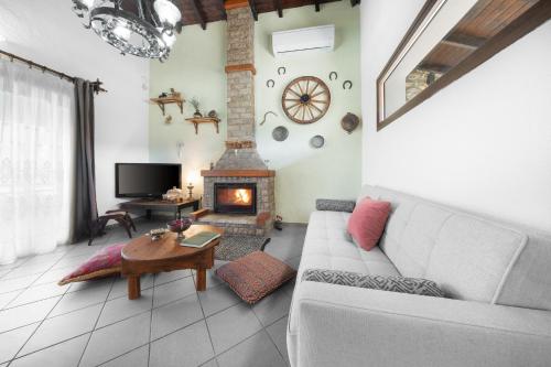 a living room with a couch and a fireplace at Chalet Renata 1 Livadi Arachovas in Kalívia