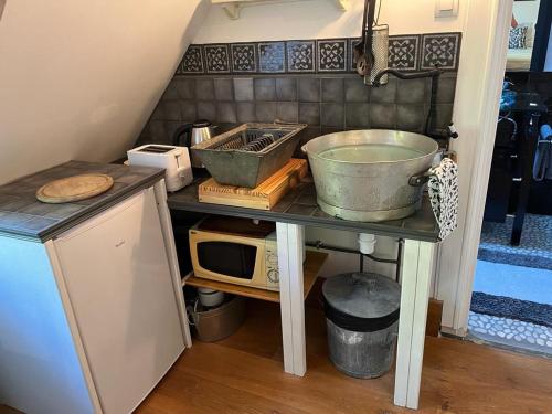 a kitchen counter with a sink and a bowl on a table at LE PARC DU VIVIER in Fernestrelay