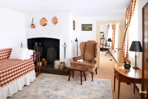 a living room with a chair and a fireplace at Rachael's Inner Harbor Boutique Inn in Baltimore