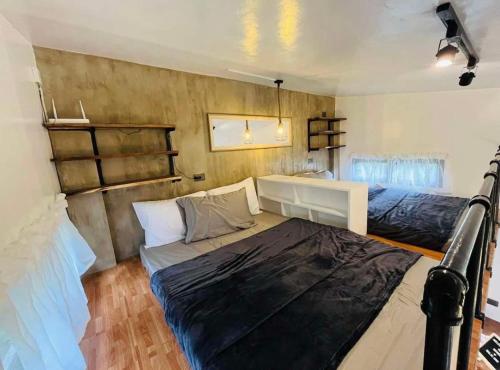a small room with two beds and a desk at Staycation with Swimming Pool Lipa Batangas in Palavit