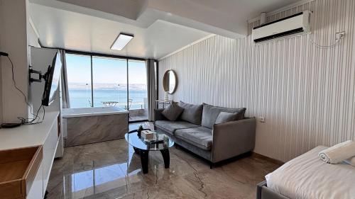 a living room with a couch and a view of the ocean at פרמיום בכינרת in Tiberias