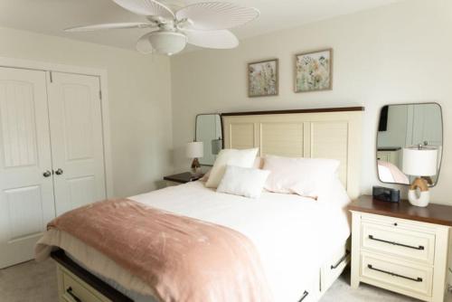 a bedroom with a large bed and a ceiling fan at 114 Austin Ave, Unit 11 in Wildwood