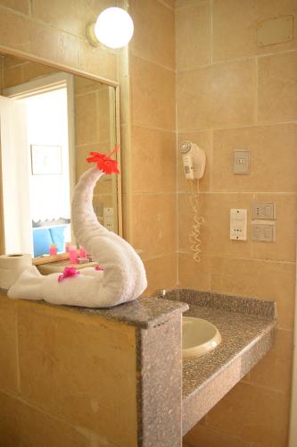 a bathroom with a towel snake on a counter at Aida Hotel Sharm El Sheikh in Sharm El Sheikh
