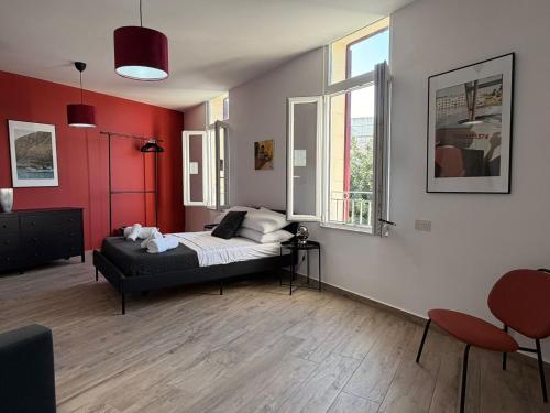 a bedroom with a bed in a room with red walls at Peprina Apt 1 in Central Rabat in Rabat