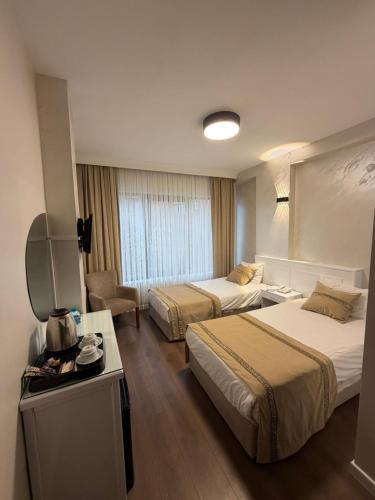 a hotel room with two beds and a television at Fatih Resadiye Hotel in Istanbul