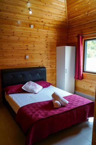 Moonking Chalet في Langkawi Islands: غرفة نوم مع سرير في غرفة خشبية