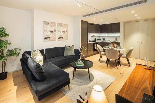 a living room with a couch and a table at Stylish 1BR Escape - Gym -Balcony - Lift in London