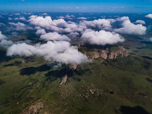 an aerial view of a mountain with clouds on it at Mount Everest Guest Farm in Harrismith