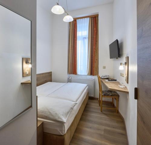 een hotelkamer met een bed en een bureau bij Hotel Terminus in Wenen
