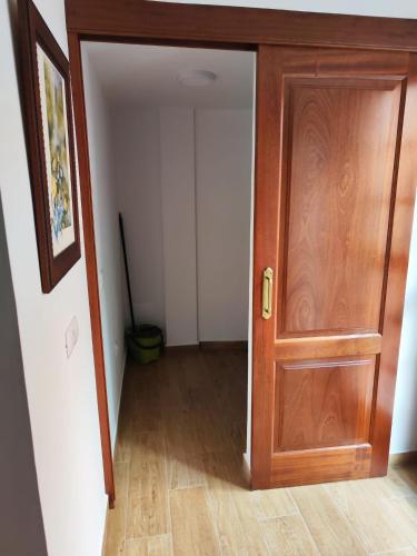 an empty hallway with a wooden door in a room at Bernal I, II y III in Los Sauces