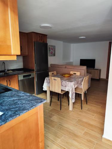 a kitchen and dining room with a table and a couch at Bernal I, II y III in Los Sauces