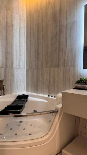 a bath tub in a bathroom with a sink at Hanay Studio in Al Khobar