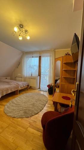 a bedroom with a bed and a rug at Pokoje Ewka in Czarna Góra