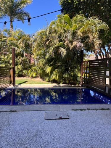 a swimming pool in a yard with palm trees at PARADISE, in Taheima, Nuevo Vallarta in Nuevo Vallarta