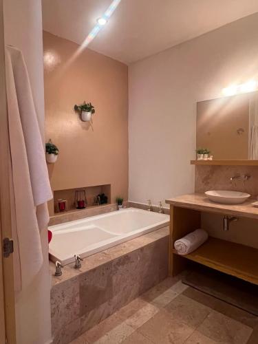 a large bathroom with a tub and a sink at PARADISE, in Taheima, Nuevo Vallarta in Nuevo Vallarta