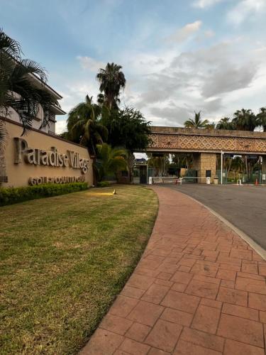 a building with a sign that reads palletsville college at PARADISE, in Taheima, Nuevo Vallarta in Nuevo Vallarta