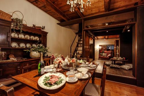 a dining room with a table with a bottle of wine at Antiques Nagoya Station East -アンティークス名古屋駅東- in Nagoya