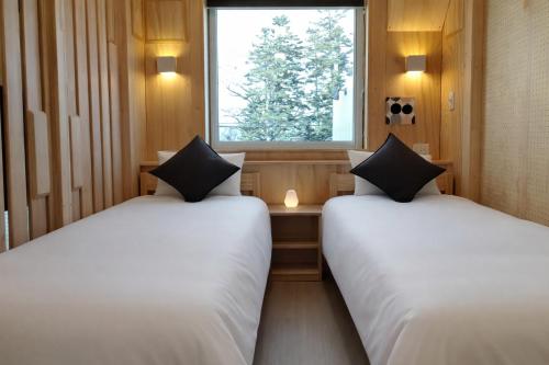 En eller flere senge i et værelse på ATTA Toya - Lake Resort