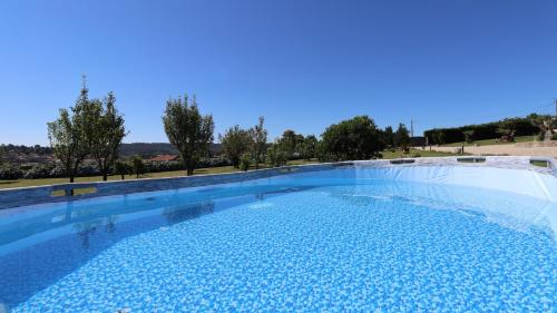 a large swimming pool with blue water at Refúgio da Natureza Stay in Monte Córdova