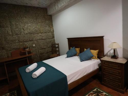 una camera da letto con un letto con due asciugamani arrotolati di Refúgio da Natureza a Monte Córdova