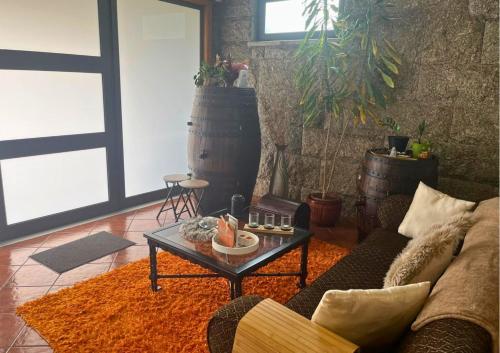 a living room with a couch and a coffee table at Refúgio da Natureza Stay in Monte Córdova