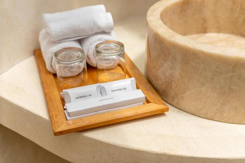 een dienblad met glazen potten en handdoeken op een aanrecht bij Umawana Villas in Tegalalang