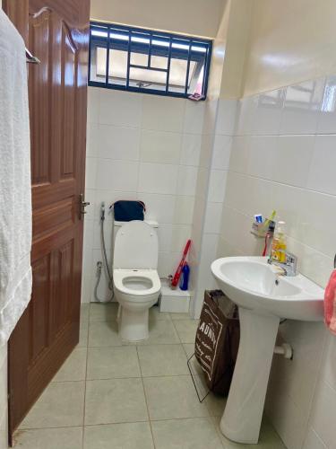 a bathroom with a toilet and a sink at Rees haven in Nanyuki